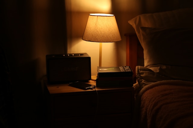 Peaceful bedroom with a white noise machine for sleep on a bedside table