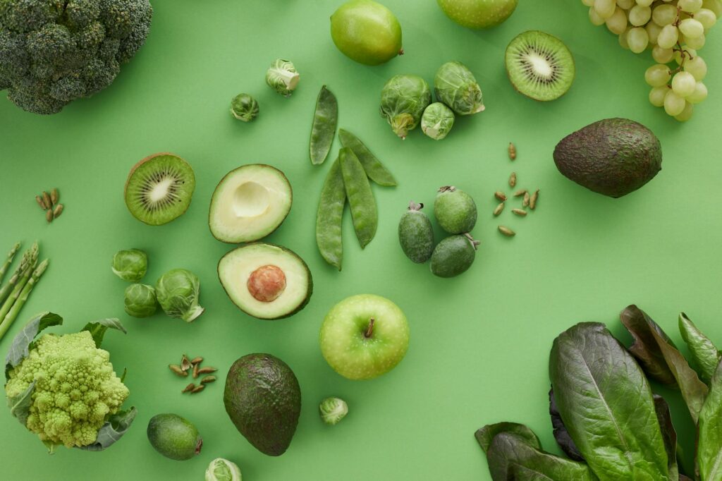 10 Magnesium-Rich Foods That Improve Sleep, Mood & Energy A colorful spread of magnesium-rich foods including spinach, pumpkin seeds, dark chocolate, avocado, almonds, and salmon on a wooden table
