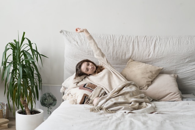 Person waking up at a consistent time learning how to fix sleep schedule with morning light