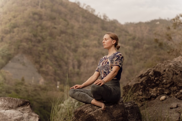 woman meditating calm outdoors stress relief