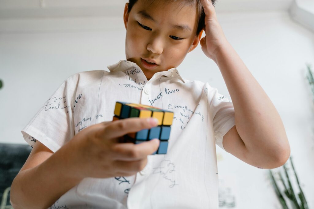 boy indulge in solving a rubik's cube 