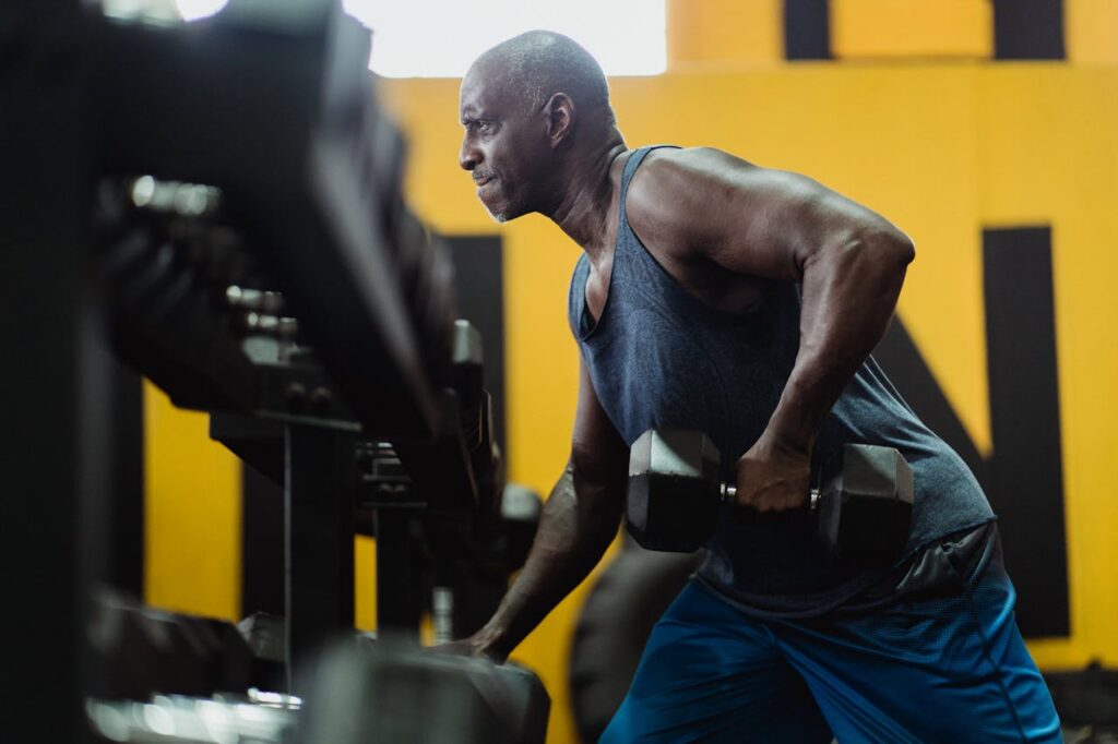 dumbbell back exercises man performing bent over row gym training posterior chain