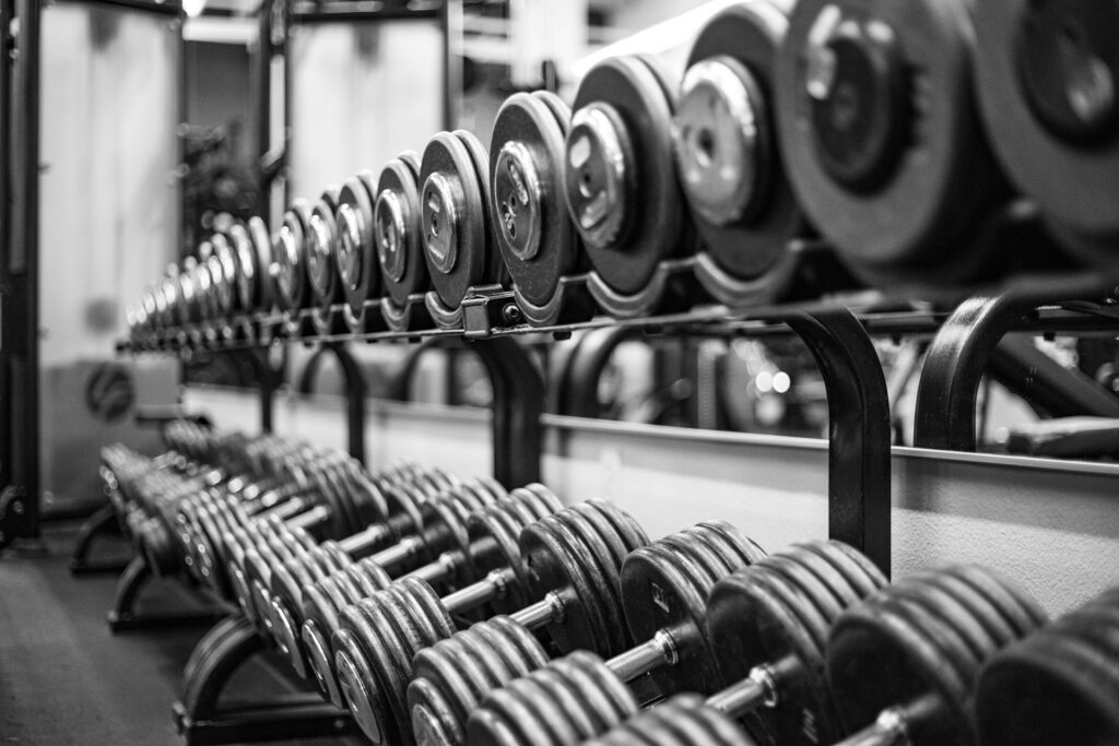dumbbell back exercises man performing bent over row gym training posterior chain