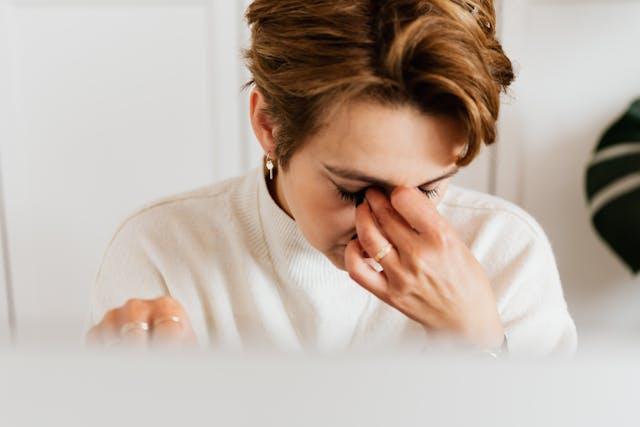 woman with hormone imbalance symptoms looking fatigued and stressed
