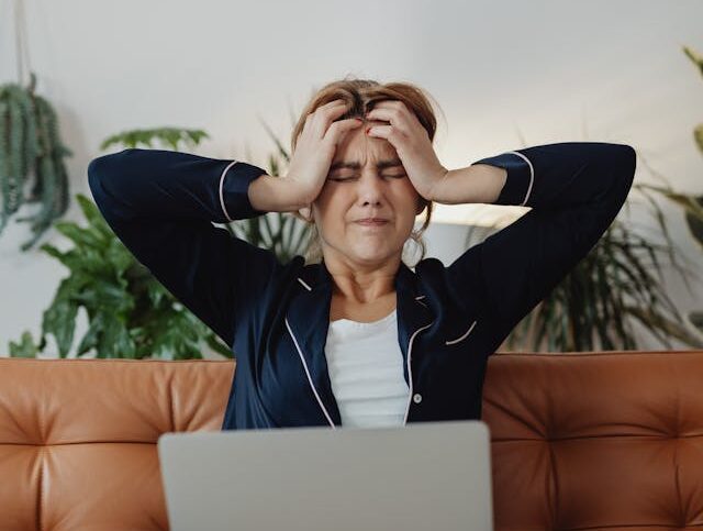 woman experiencing horrible perimenopause symptoms looking tired and overwhelmed at home