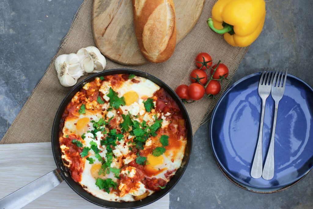 shakshuka eggs in spiced tomato sauce mediterranean diet breakfast recipe in cast iron pan