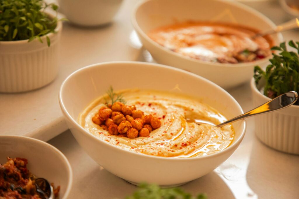 mediterranean diet lunch bowl with roasted vegetables hummus and fresh herbs