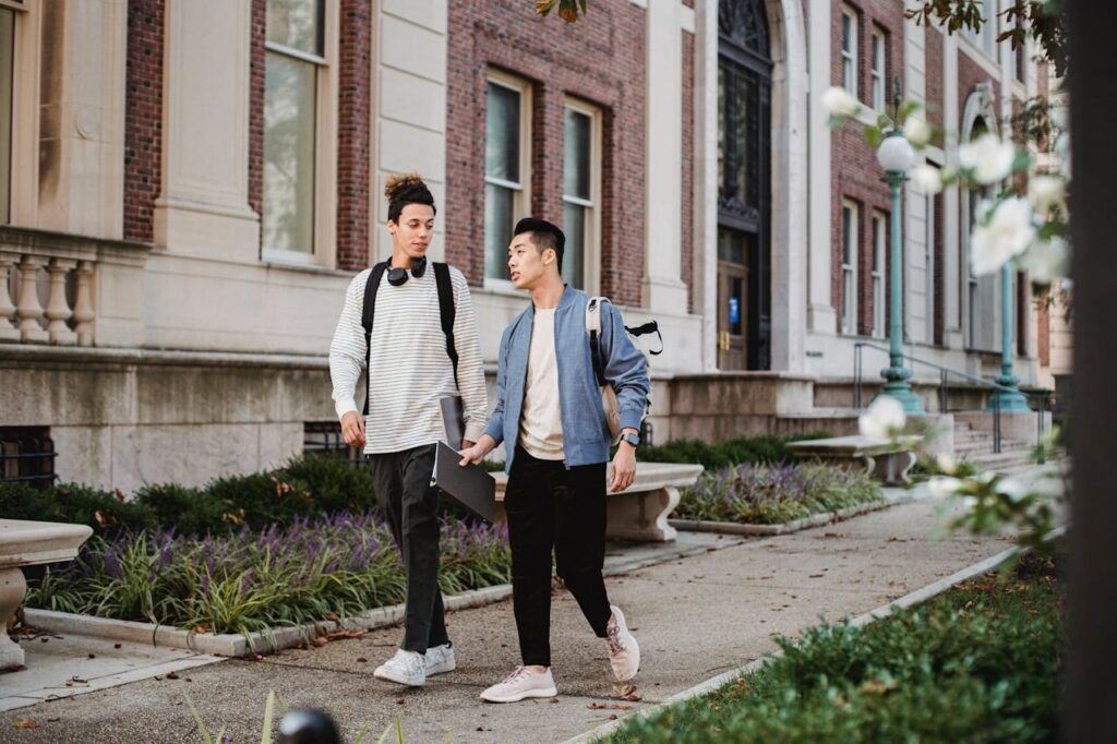 two men talking outdoors walking together supporting mens mental health month conversation