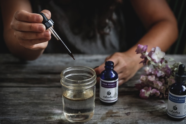 oil of oregano with black seed oil bottles on wooden surface natural wellness supplements