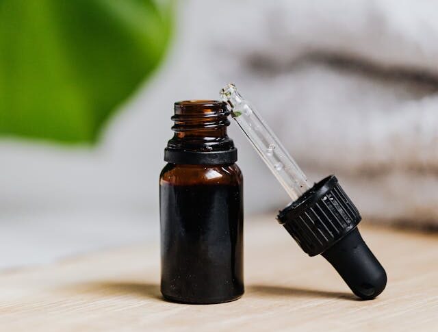organic castor oil bottle with dropper on wooden surface natural wellness beauty