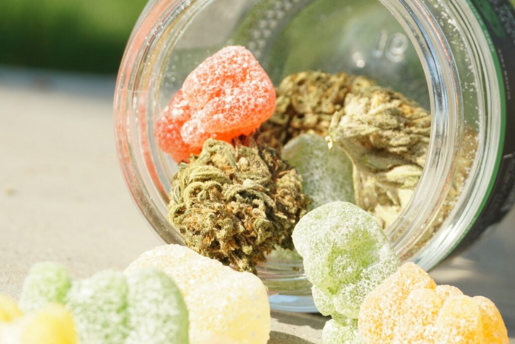 CBD Gummies for Pain: How They Work, Dosage & What to Look For CBD gummies and hemp leaves on a wooden surface